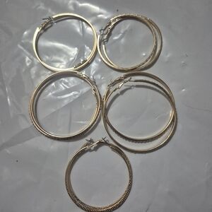 Five pairs of gold tone hooped earrings